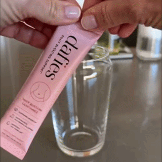 Pouring a dafies stick pack into a glass of water